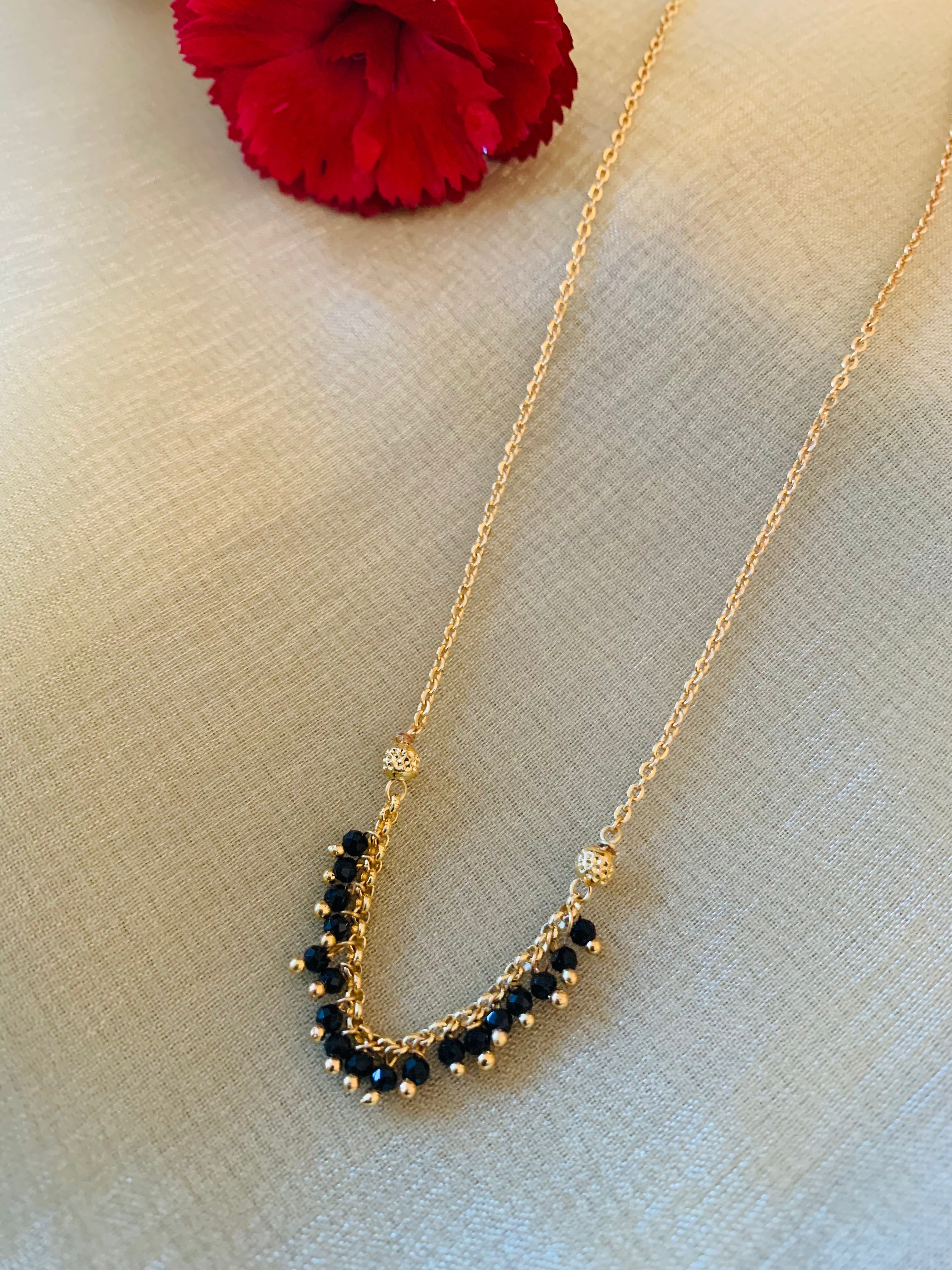 Gold and 2025 black bead necklace